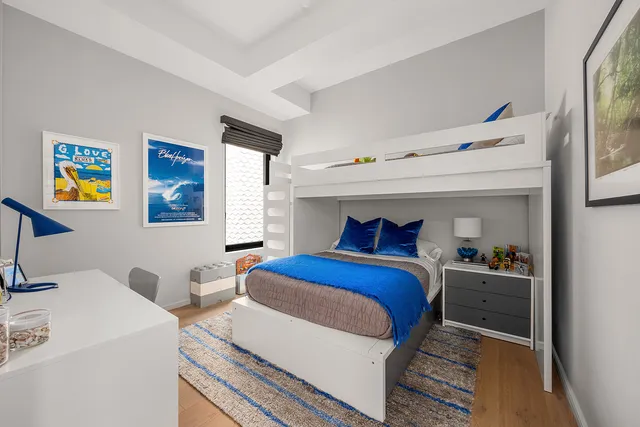 a bedroom with a bed and a painting on the wall