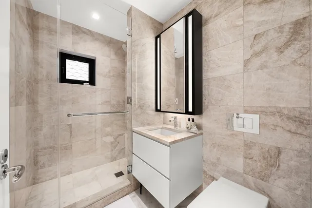 a bathroom with a toilet sink and shower