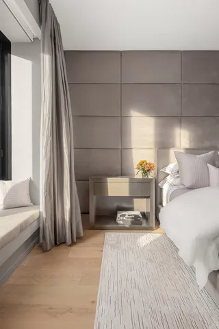 a bedroom with a bed and a mirror