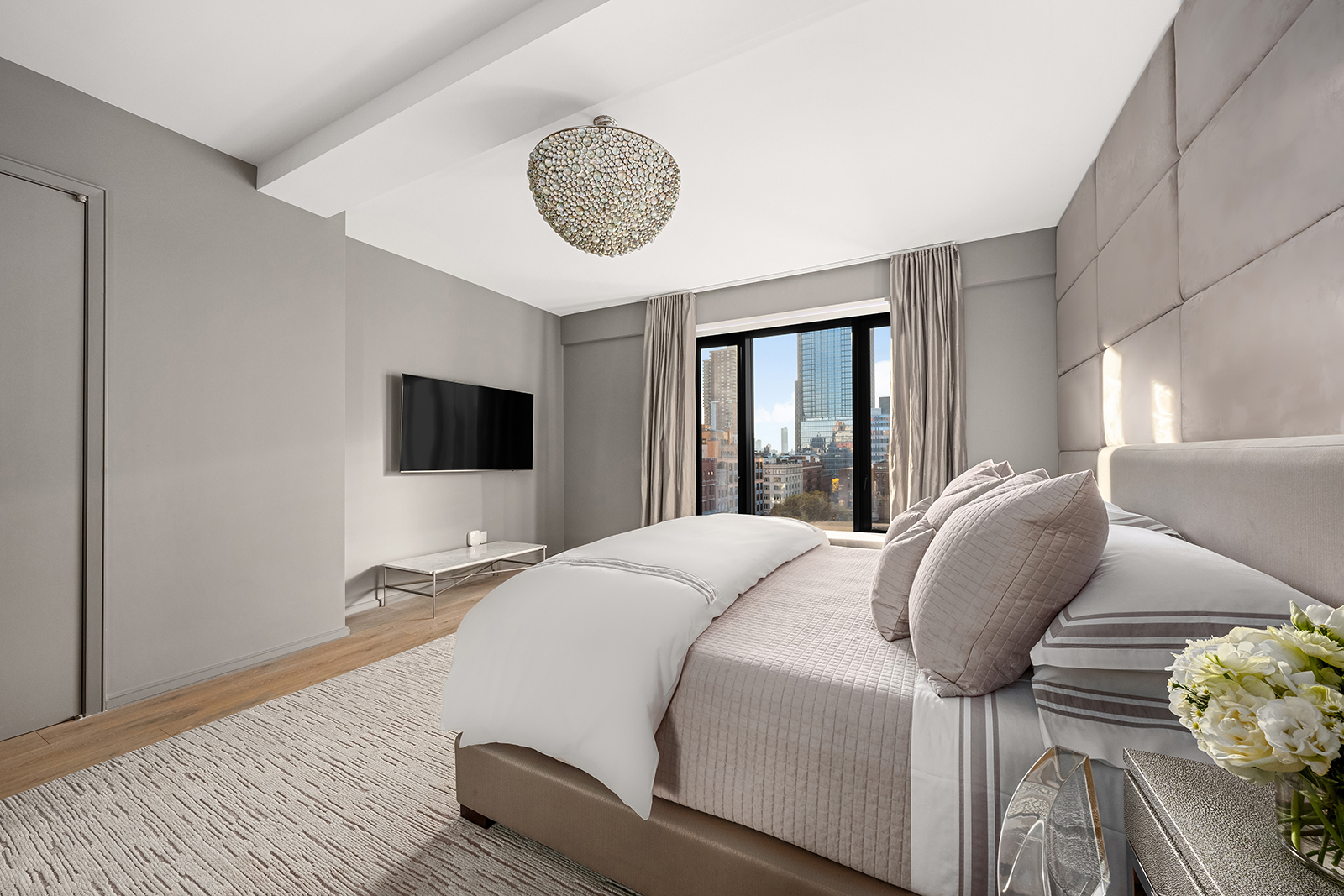 11 Beach Street, Unit 8A Manhattan, NY 10013 - Photo 8 of 23 a bedroom with a bed and a chandelier