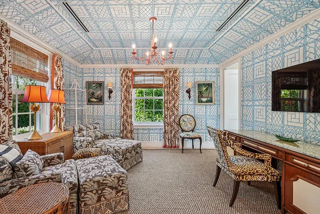 a bedroom with a bed a chandelier and couch