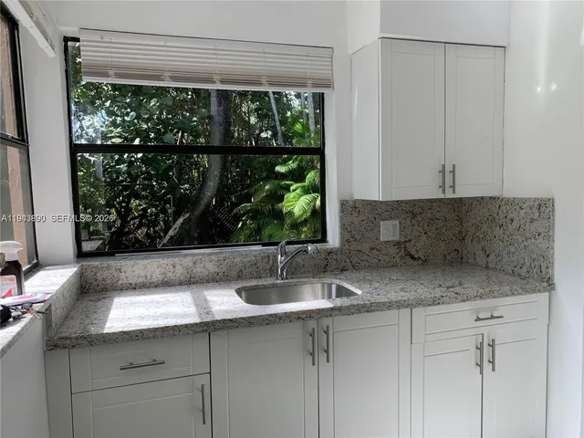 a sink with a granite top and a sink