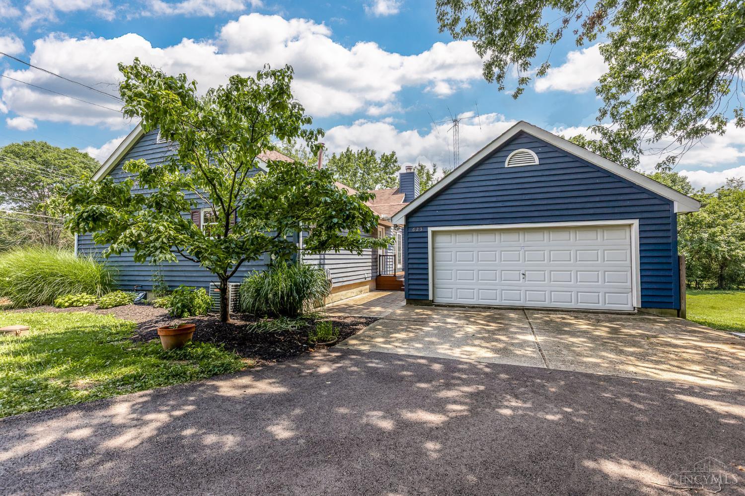 623 Ibold Road Loveland, OH 45140 - Photo 28 of 35 Set back on a scenic one-acre lot, the home is complemented by an oversized driveway, detached two-car garage, and thoughtfully landscaped grounds that enhance both privacy and curb appeal.