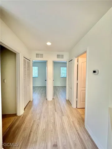 a view of hallway with wooden floor