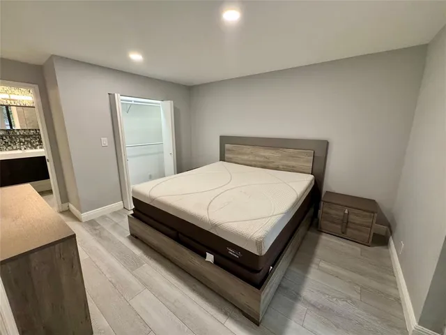 a bed sitting in a bedroom next to a window