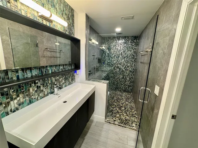 a bathroom with a sink and mirror