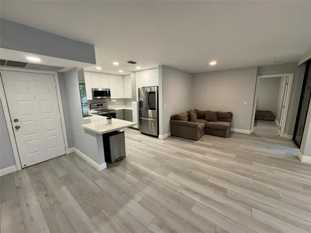a kitchen with a refrigerator and a sink