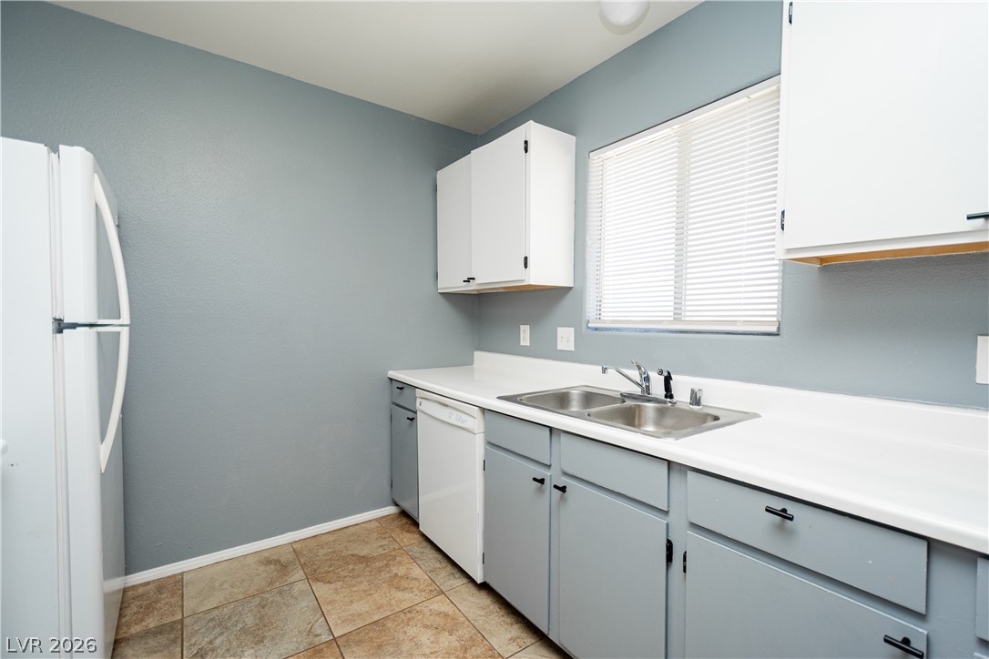 1444 Star Road Pahrump, NV 89048 - Photo 10 of 37 Streamlined cabinetry and classic tiled floors define this functional kitchen workspace.
