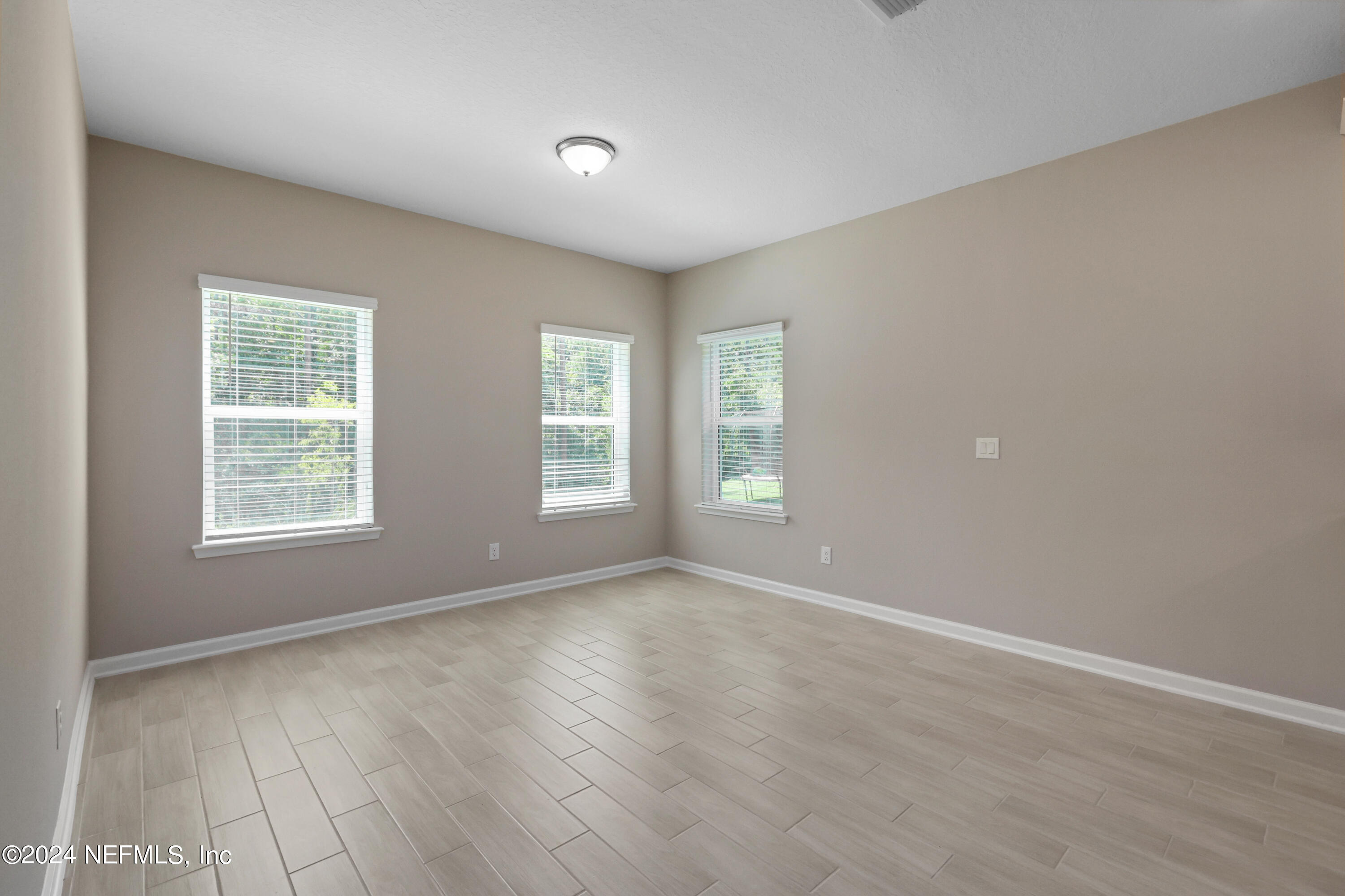 75605 Blackbird Drive Yulee, FL 32097 - Photo 15 of 46 an empty room with windows and closet