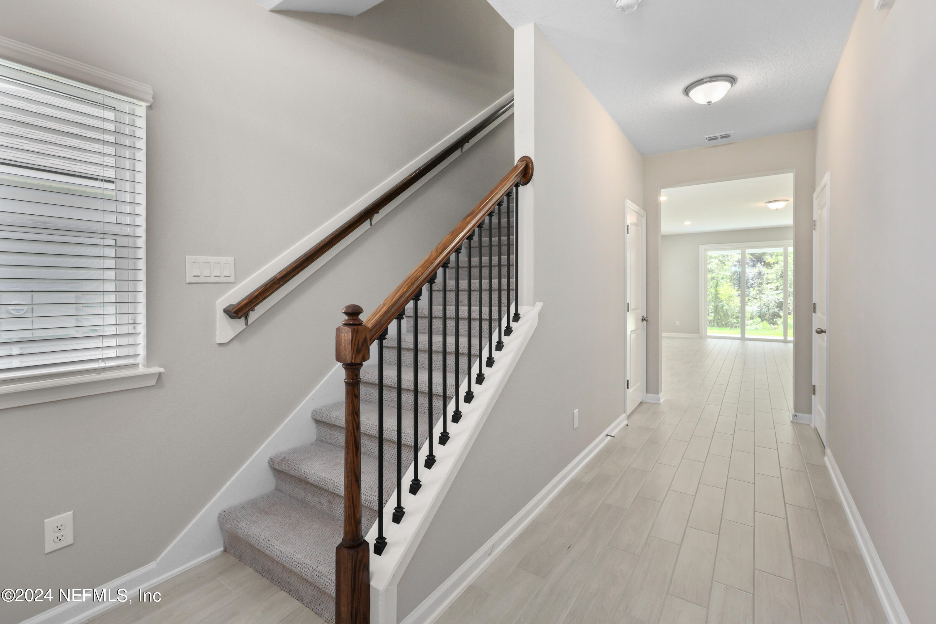 75605 Blackbird Drive Yulee, FL 32097 - Photo 17 of 46 a view of a hallway with wooden floor and staircase