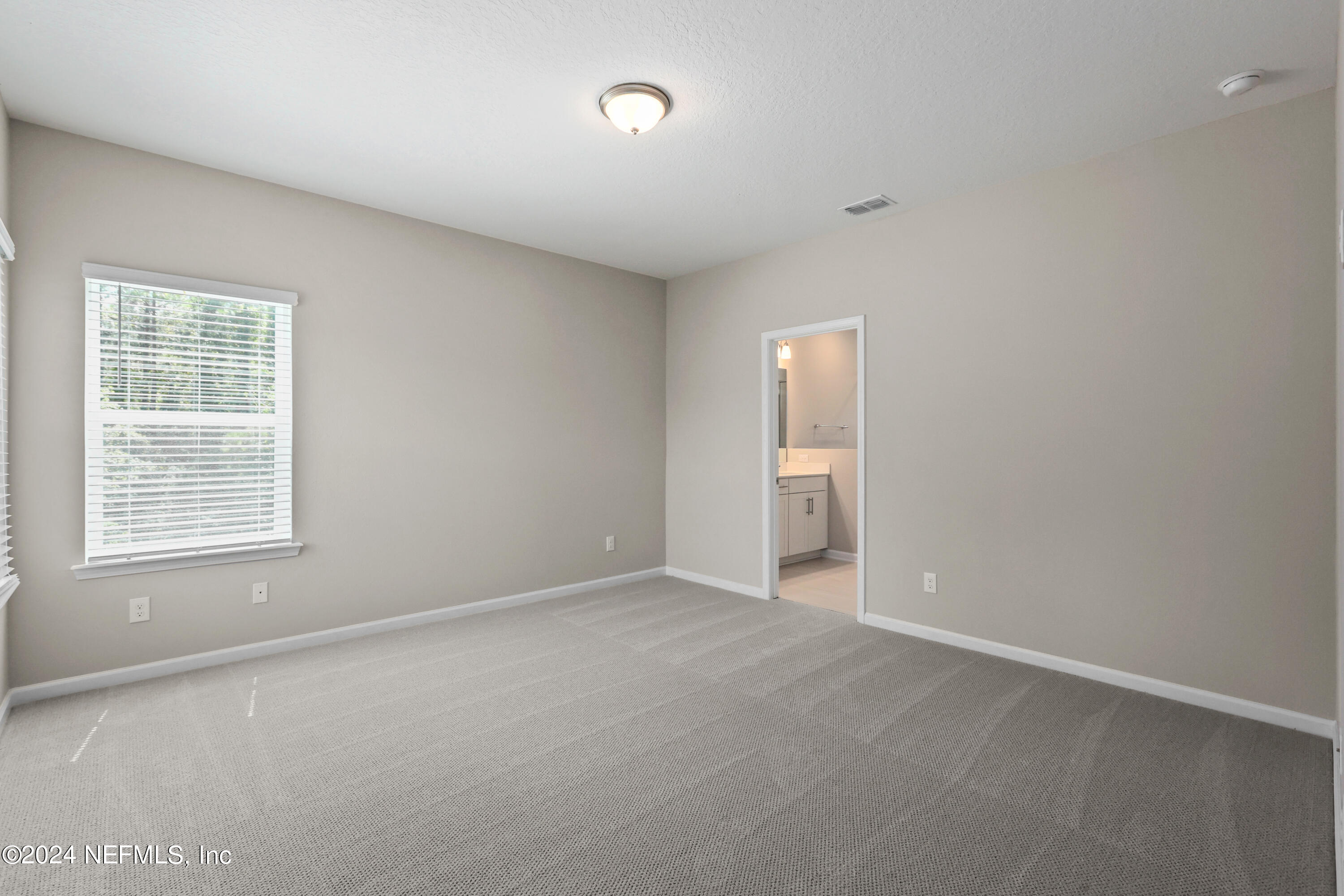 75605 Blackbird Drive Yulee, FL 32097 - Photo 20 of 46 a view of an empty room with a window