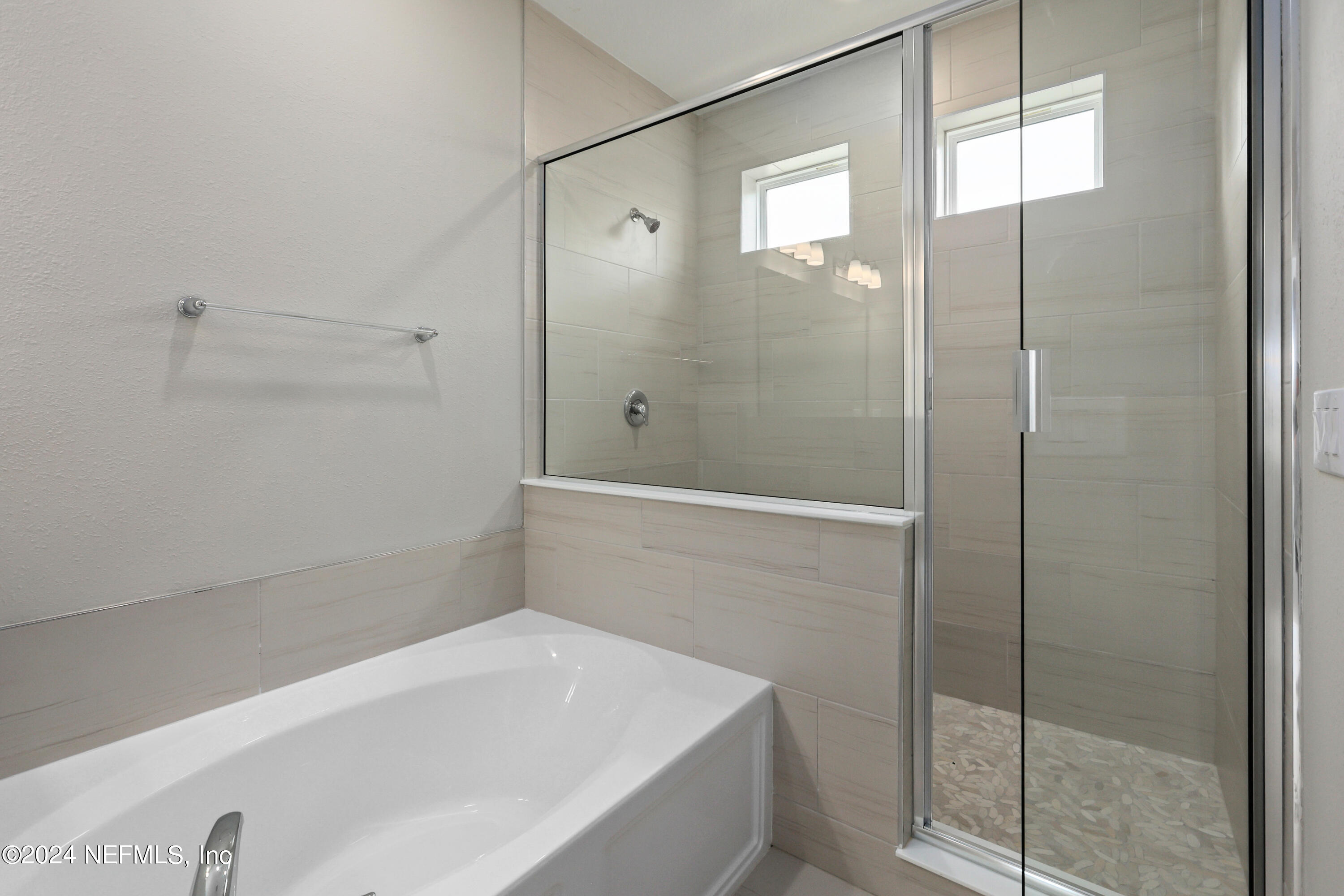 75605 Blackbird Drive Yulee, FL 32097 - Photo 21 of 46 a bathroom with a bathtub and shower
