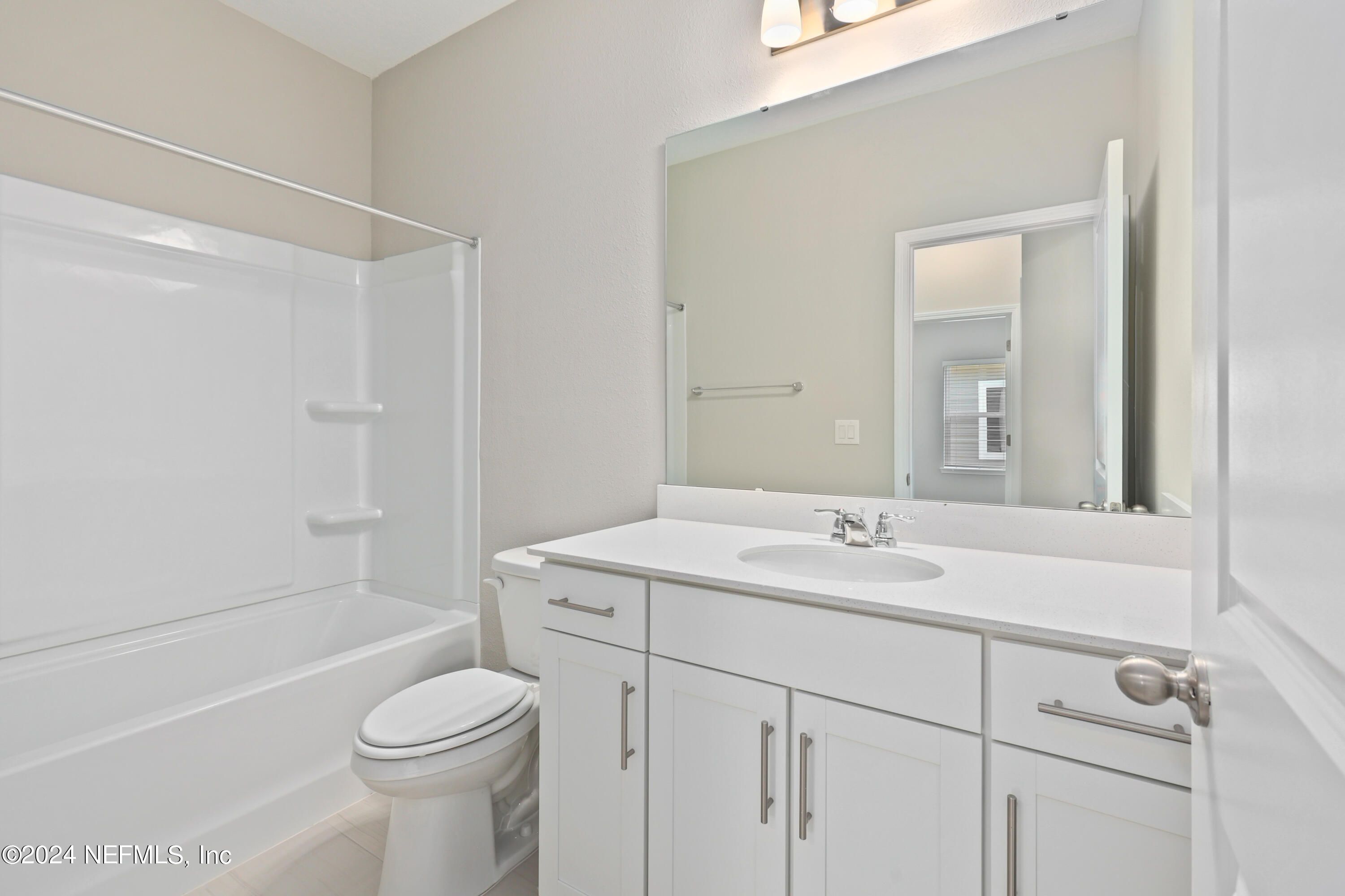 75605 Blackbird Drive Yulee, FL 32097 - Photo 25 of 46 a bathroom with a sink toilet vanity and shower