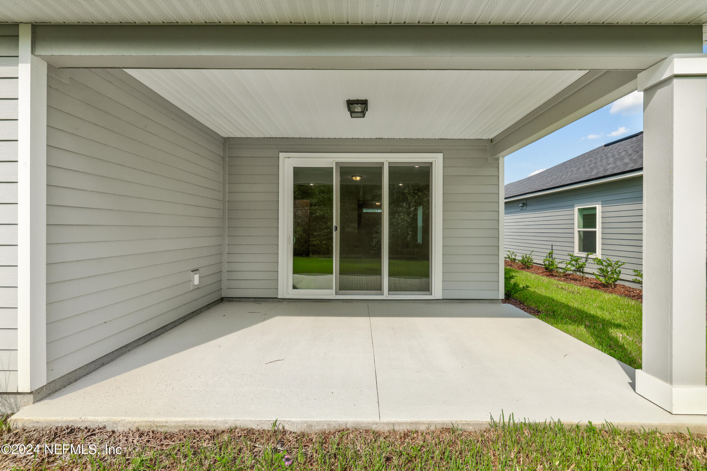 75605 Blackbird Drive Yulee, FL 32097 - Photo 28 of 46 a front view of a house with a yard and potted plants