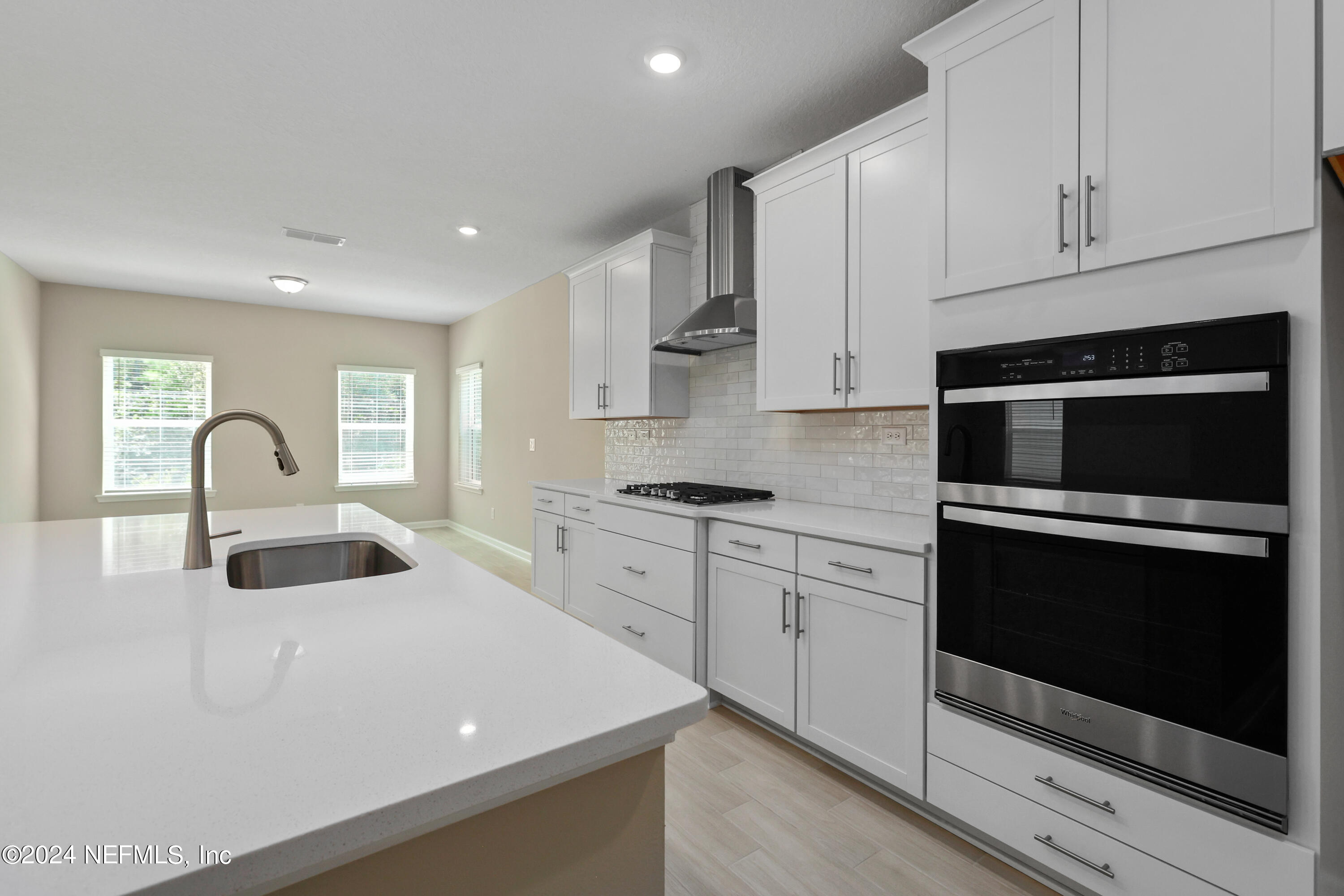 75605 Blackbird Drive Yulee, FL 32097 - Photo 3 of 46 a kitchen with sink a microwave and cabinets