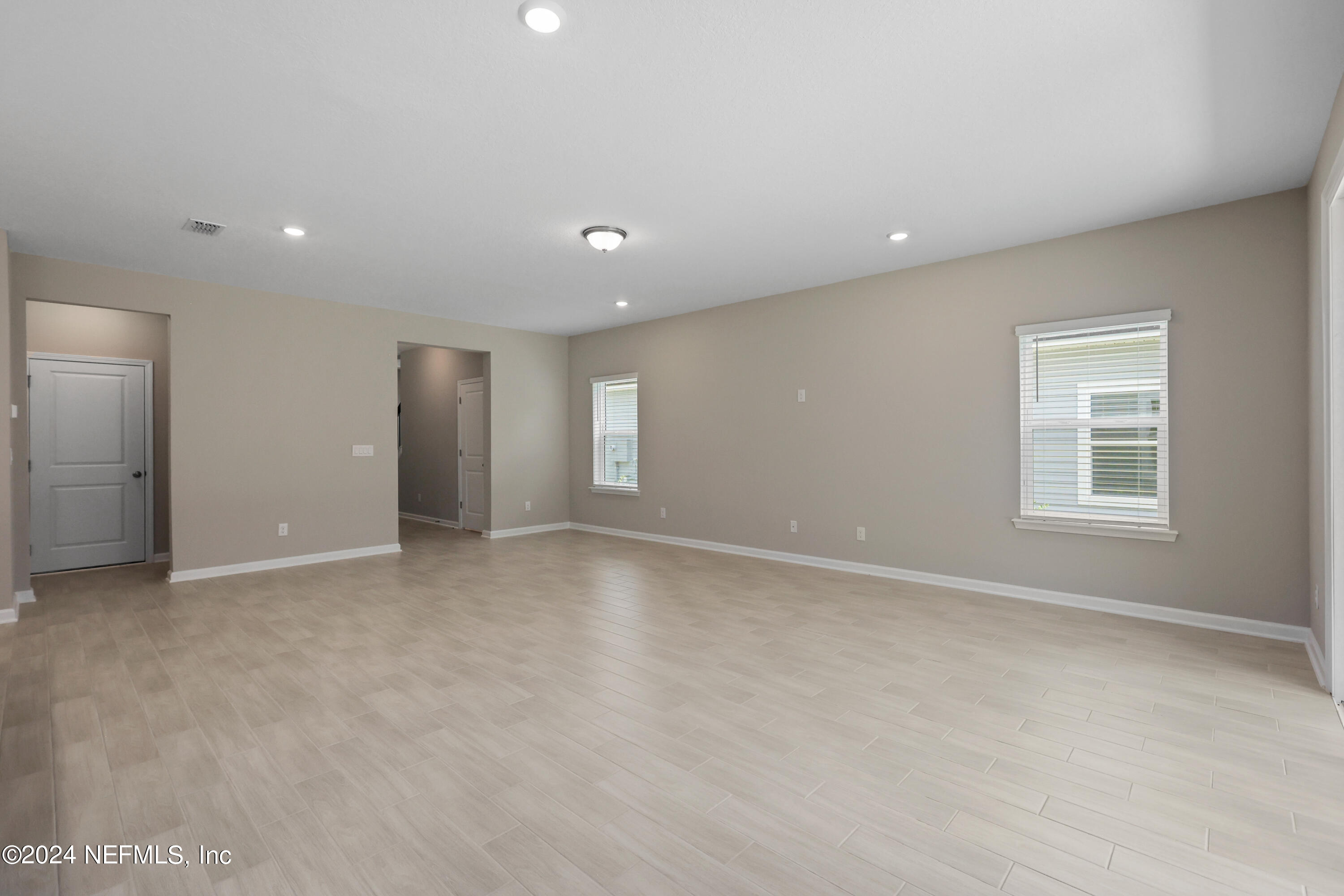 75605 Blackbird Drive Yulee, FL 32097 - Photo 9 of 46 an empty room with windows and closet