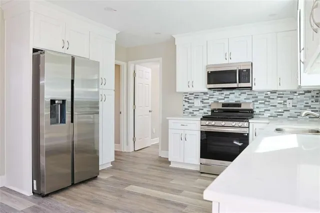 an empty room with a window and ceiling fan
