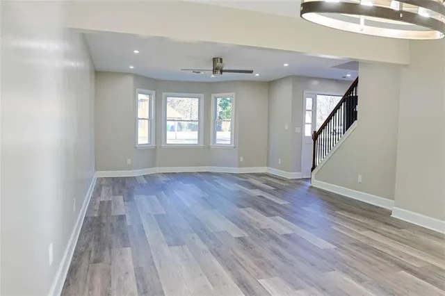 a kitchen with stainless steel appliances granite countertop a refrigerator and a stove top oven