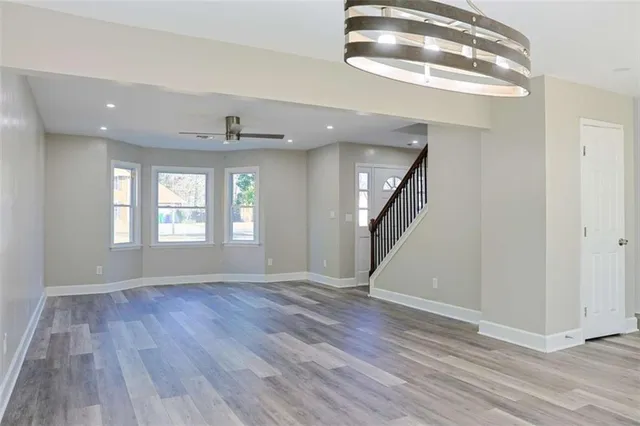a kitchen with granite countertop a stove a sink and a microwave