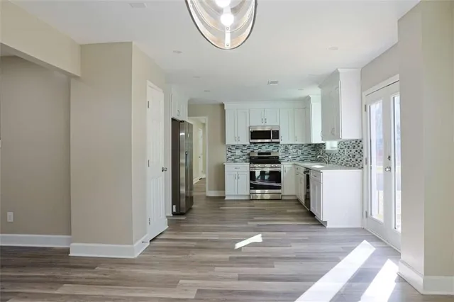 a kitchen with stainless steel appliances a refrigerator stove and microwave