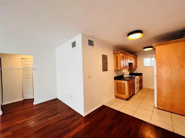 a view of a kitchen with wooden floor