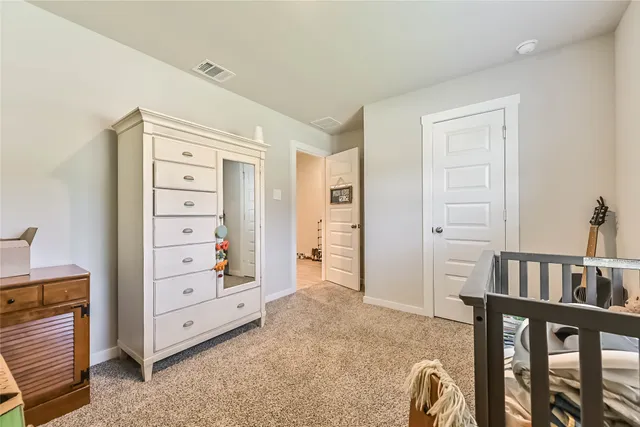 a view of bedroom with furniture and closet