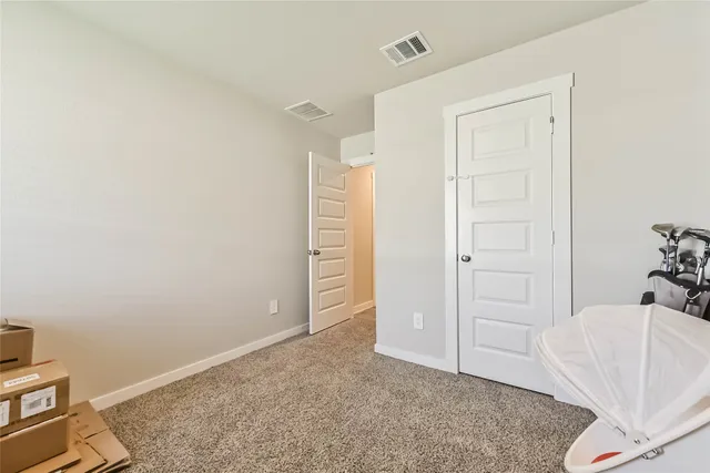 an empty room with cabinet and closet