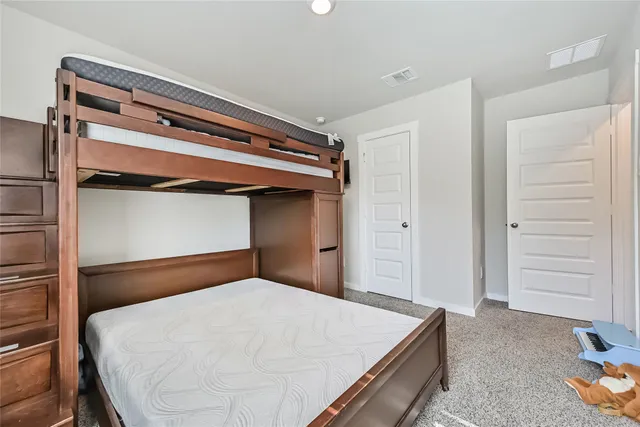 a bedroom with a bed and cabinet