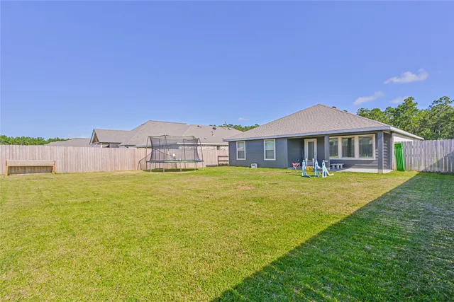 a front view of a house with swimming pool having outdoor seating