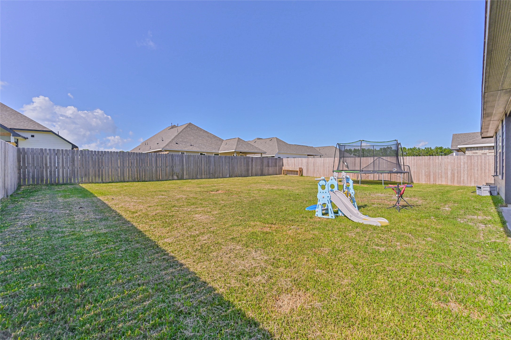 136 Little Spg Court Anahuac, TX 77514 - Photo 29 of 34 a view of a backyard with a small pool and a wooden fence