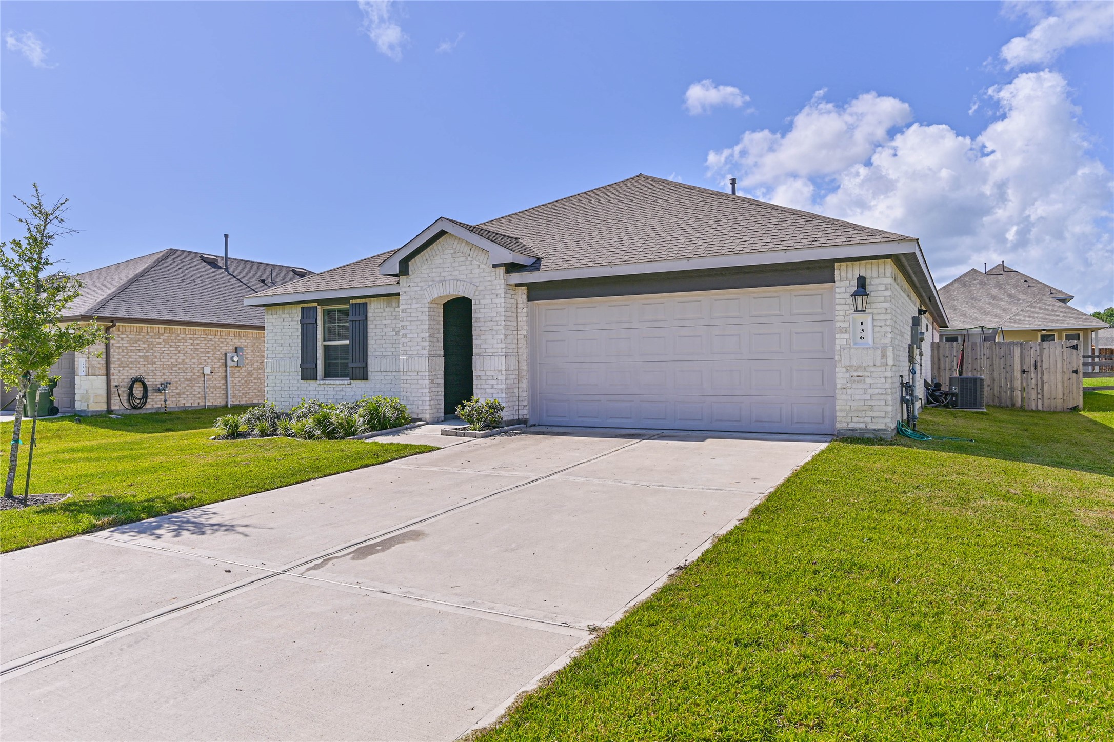 136 Little Spg Court Anahuac, TX 77514 - Photo 30 of 34 a front view of a house with a yard and garage