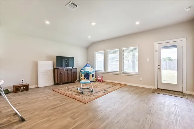 a living room with a couch and a table with wooden floor