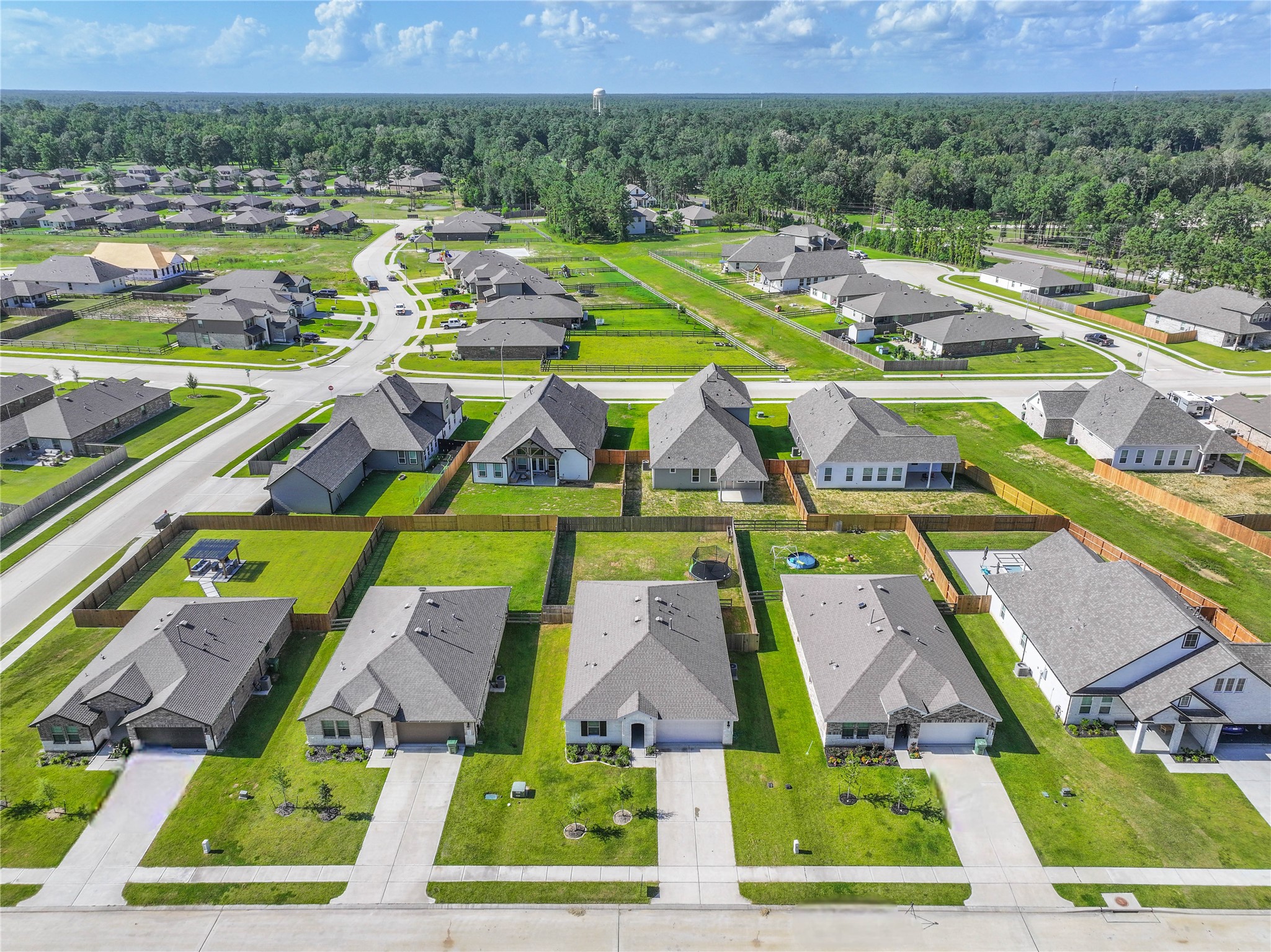 136 Little Spg Court Anahuac, TX 77514 - Photo 32 of 34 an aerial view of multiple houses with yard