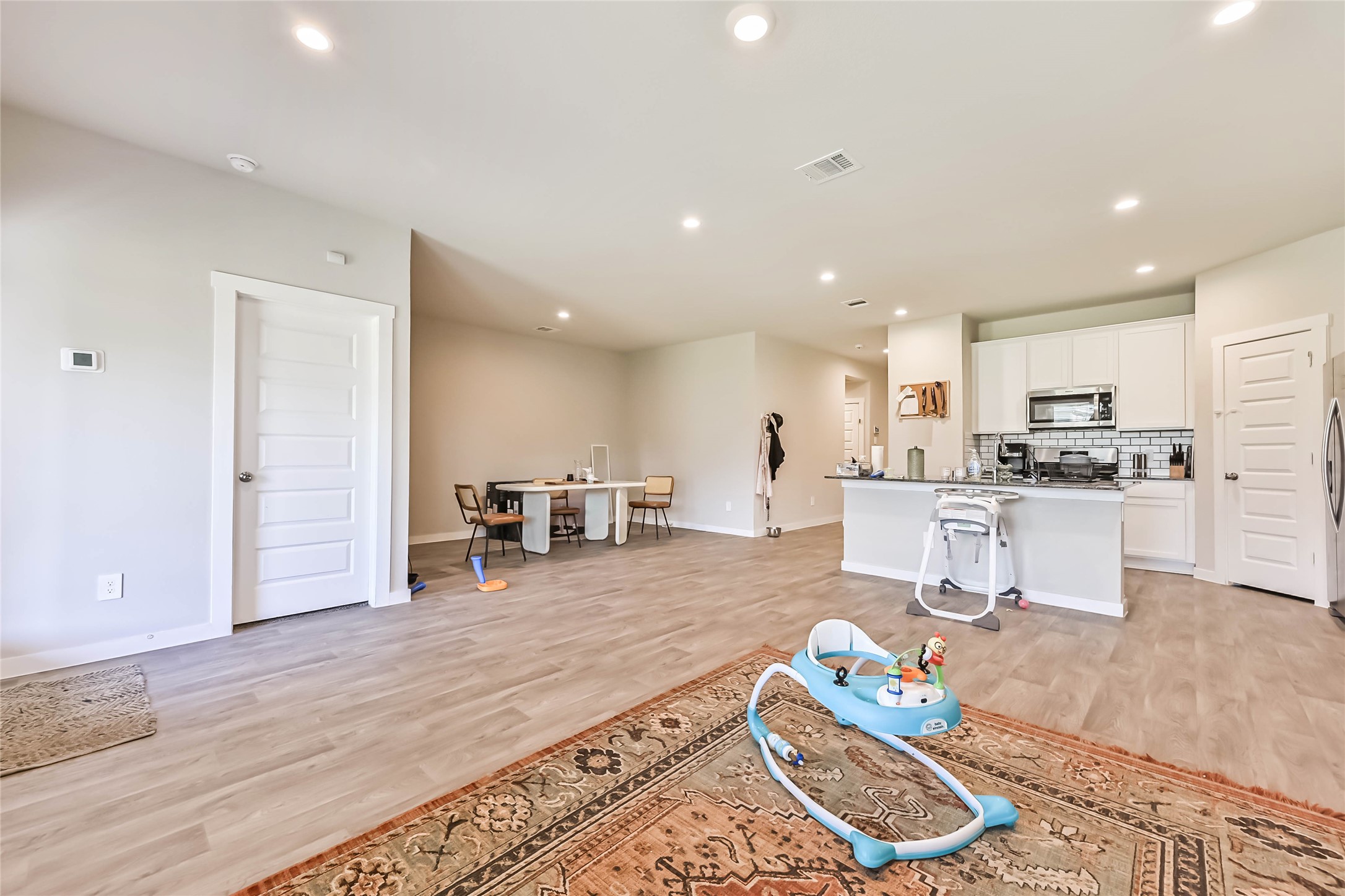 136 Little Spg Court Anahuac, TX 77514 - Photo 4 of 34 a living room with furniture and kitchen view with wooden floor