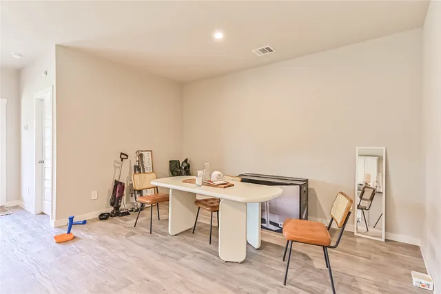 a view of a workspace with furniture and wooden floor