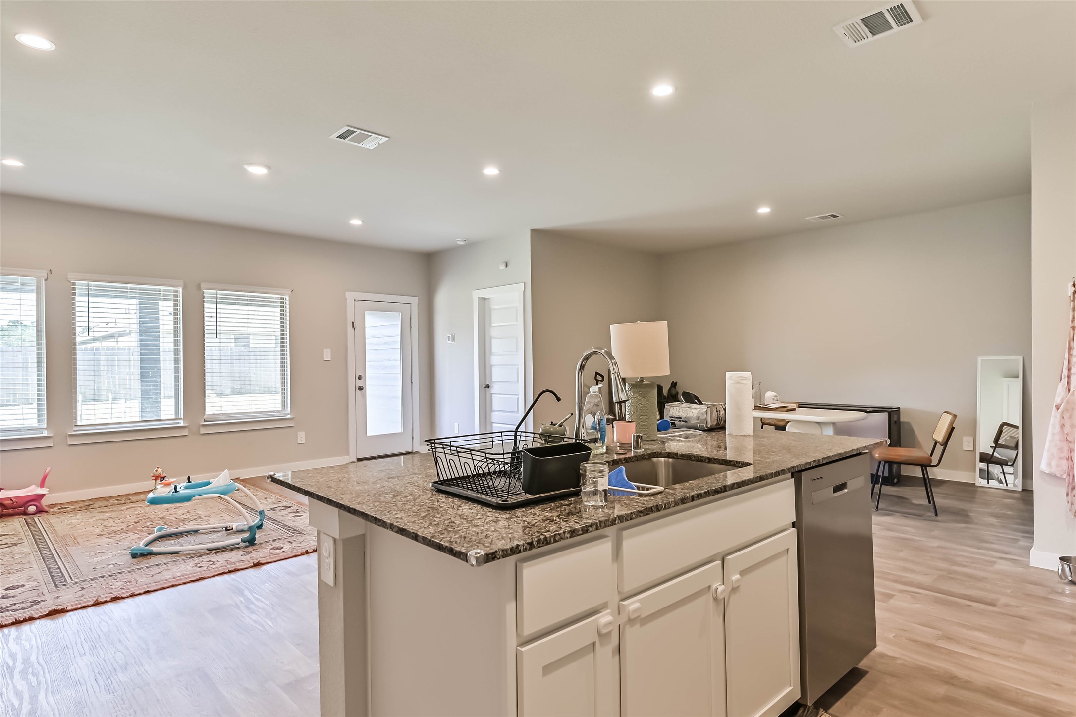 136 Little Spg Court Anahuac, TX 77514 - Photo 9 of 34 a kitchen with stainless steel appliances granite countertop a sink and a white cabinets