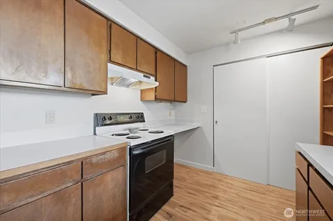 a kitchen with stainless steel appliances granite countertop a sink and a stove