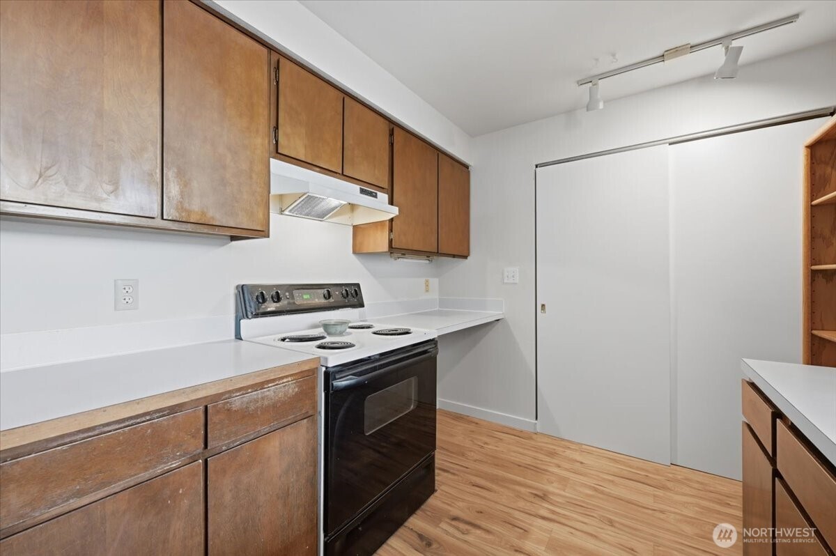 8516 196th Street Southwest, Unit 204 Edmonds, WA 98026 - Photo 6 of 16 a kitchen with stainless steel appliances granite countertop a sink and a stove