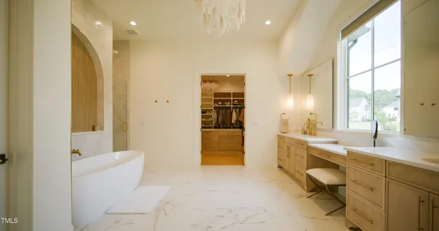 a en suite bathroom with a double vanity sink mirror and shower
