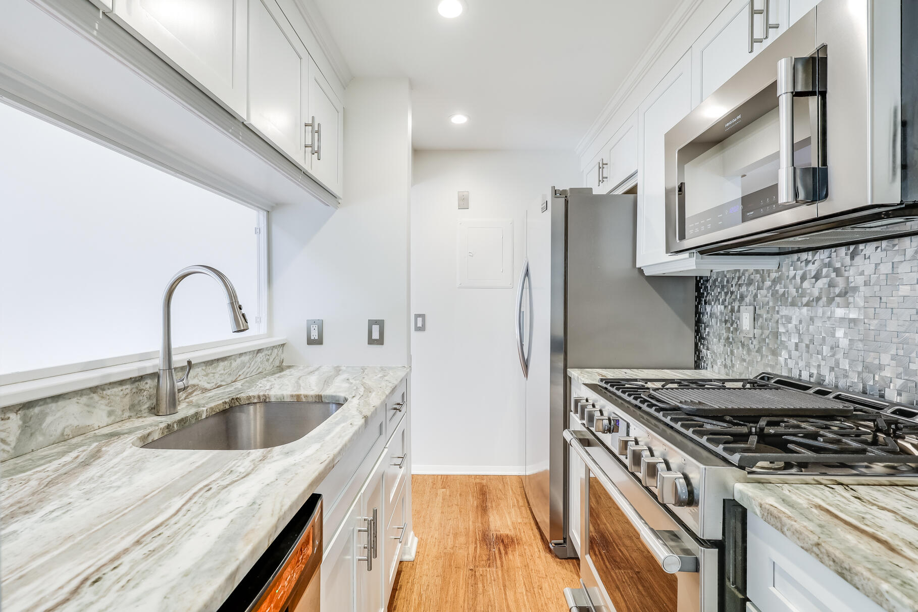68 Mid-Iron Way, Unit 7545 Mashpee, MA 02649 - Photo 11 of 43 a kitchen that has a sink and a stove