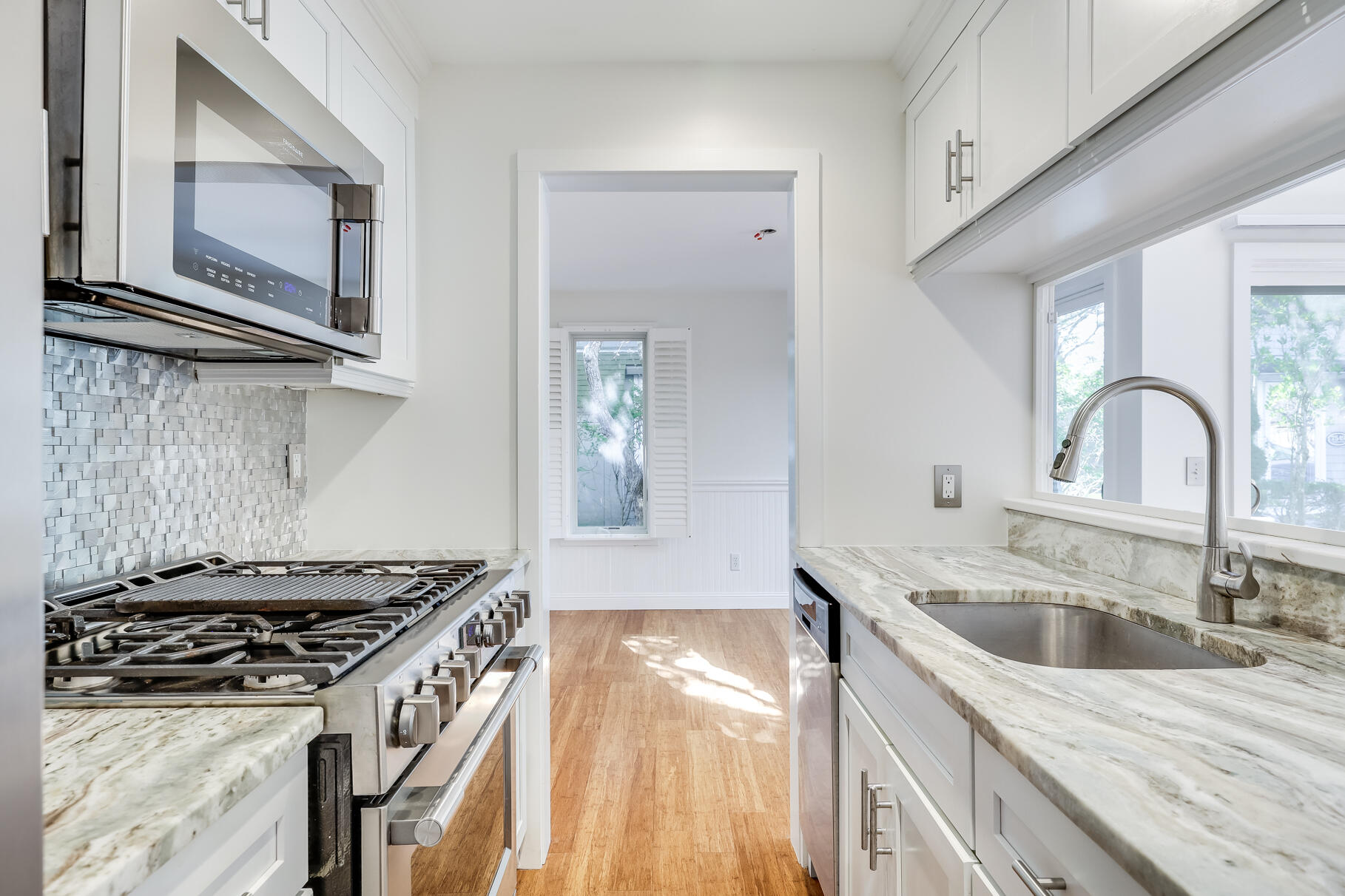 68 Mid-Iron Way, Unit 7545 Mashpee, MA 02649 - Photo 13 of 43 a kitchen with granite countertop a stove and a sink