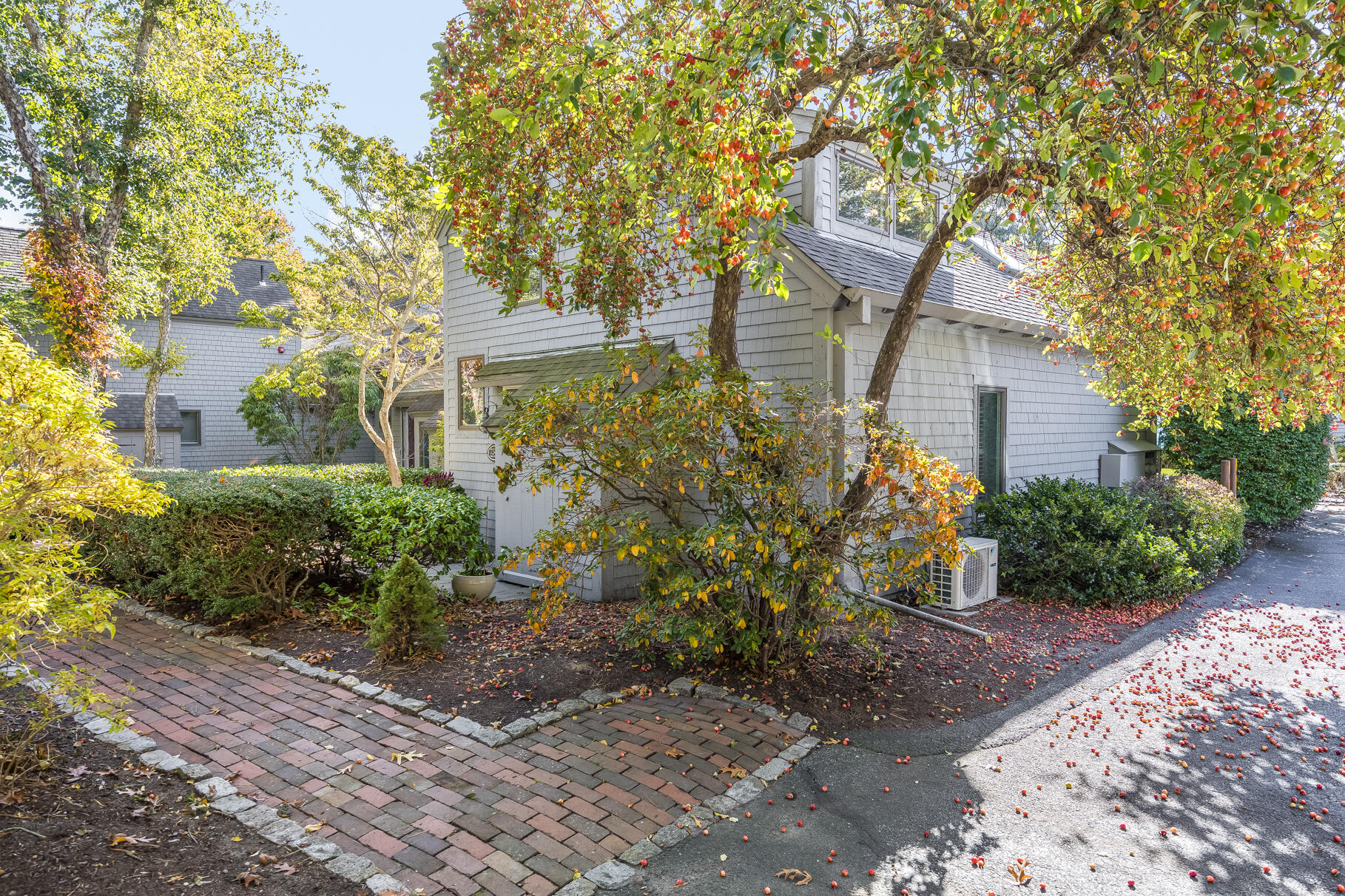 68 Mid-Iron Way, Unit 7545 Mashpee, MA 02649 - Photo 2 of 43 a front view of a house with garden