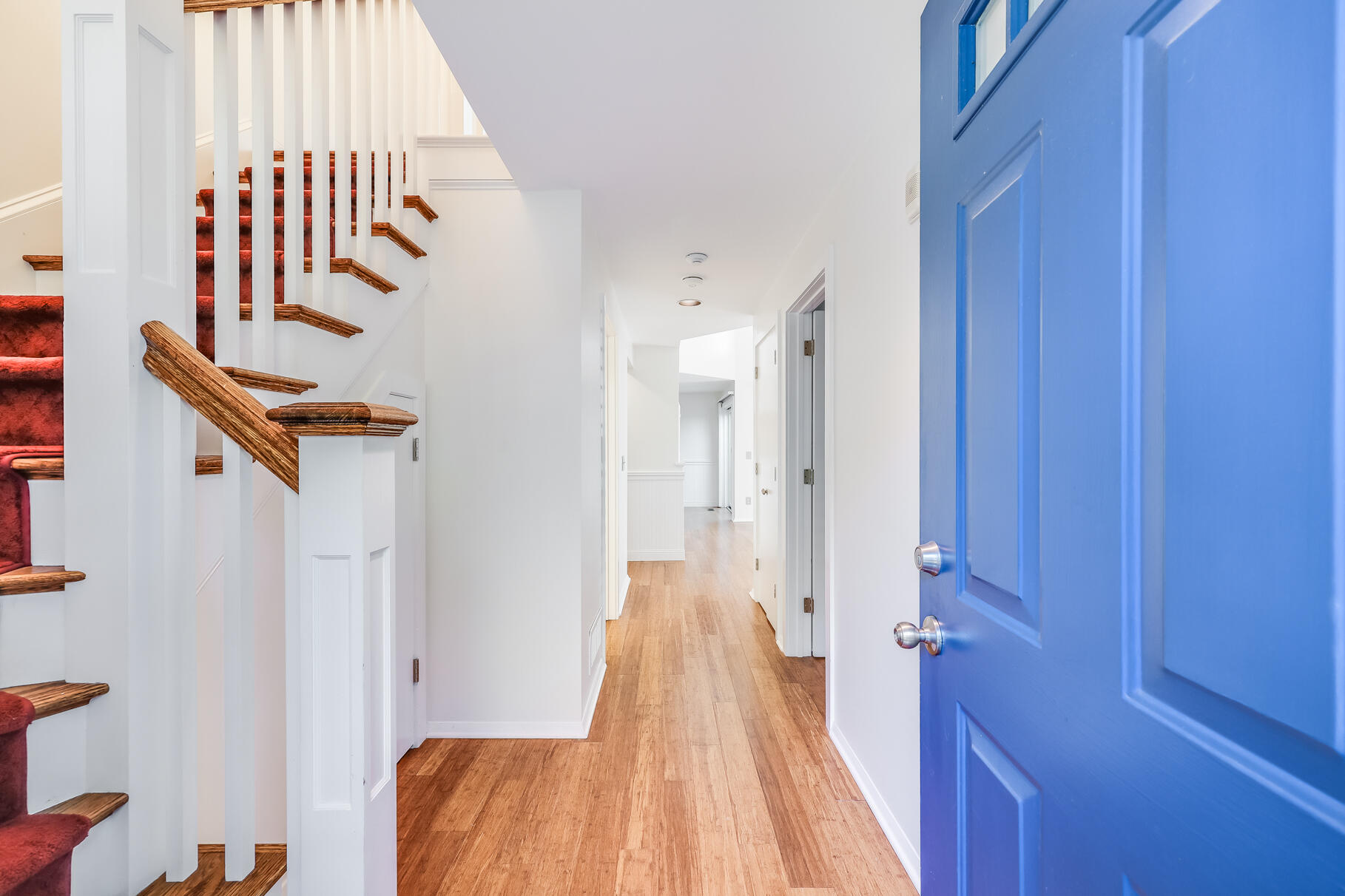 68 Mid-Iron Way, Unit 7545 Mashpee, MA 02649 - Photo 3 of 43 a view of a hallway with wooden floor and staircase