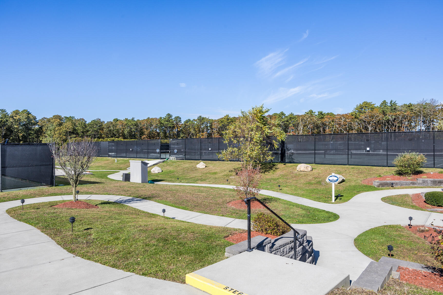68 Mid-Iron Way, Unit 7545 Mashpee, MA 02649 - Photo 33 of 43 a view of a swimming pool with a patio and a yard