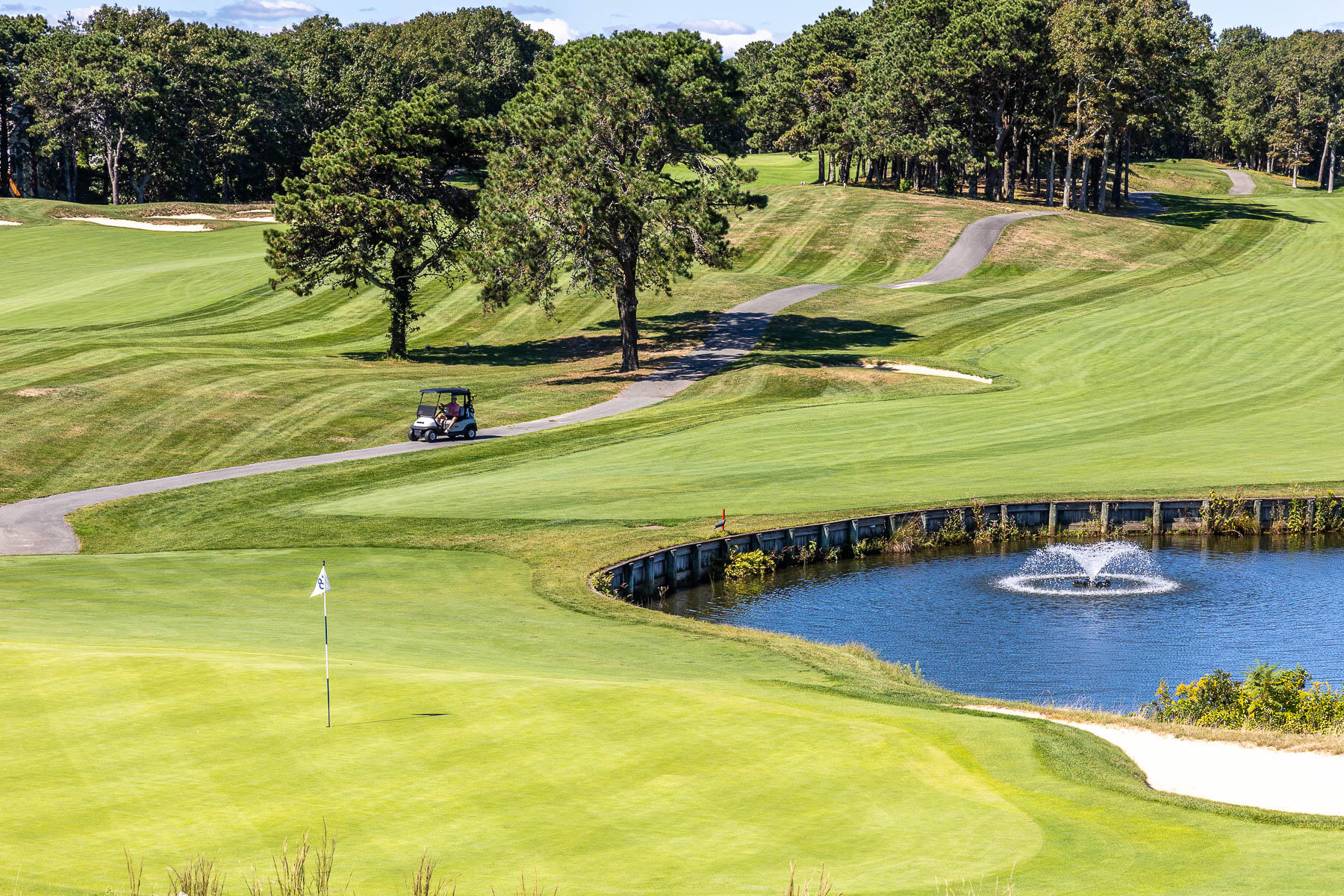 68 Mid-Iron Way, Unit 7545 Mashpee, MA 02649 - Photo 42 of 43 a view of a swimming pool with an outdoor space and seating area