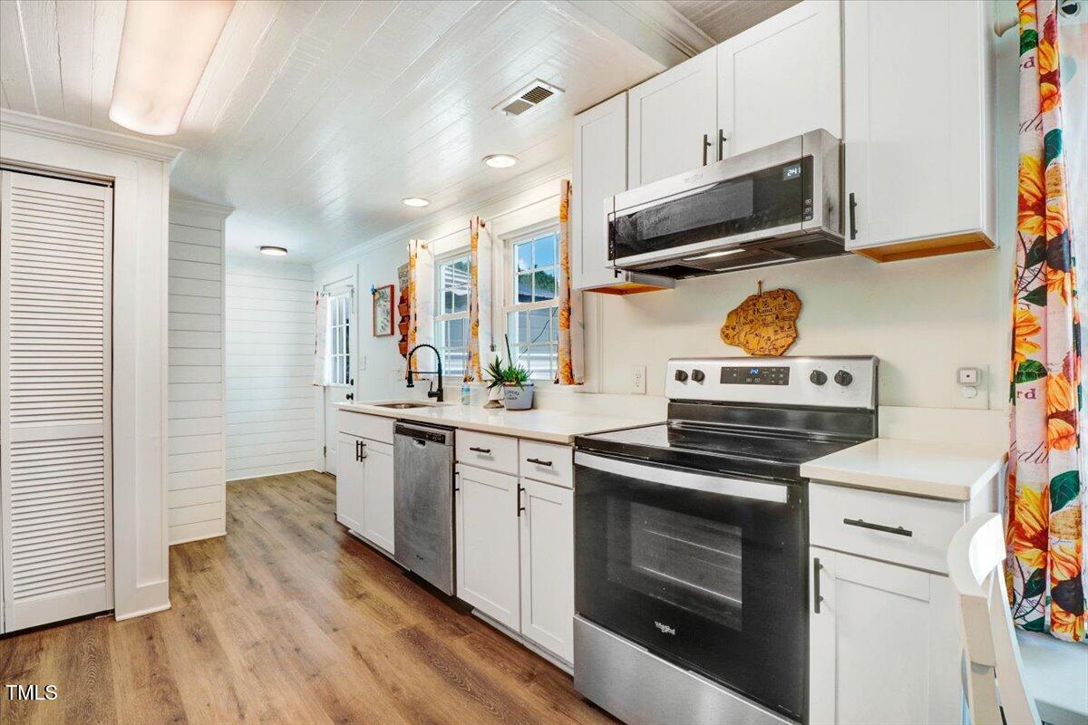 175 Debro Road Kenly, NC 27542 - Photo 11 of 30 a kitchen with stainless steel appliances a stove a sink and a microwave