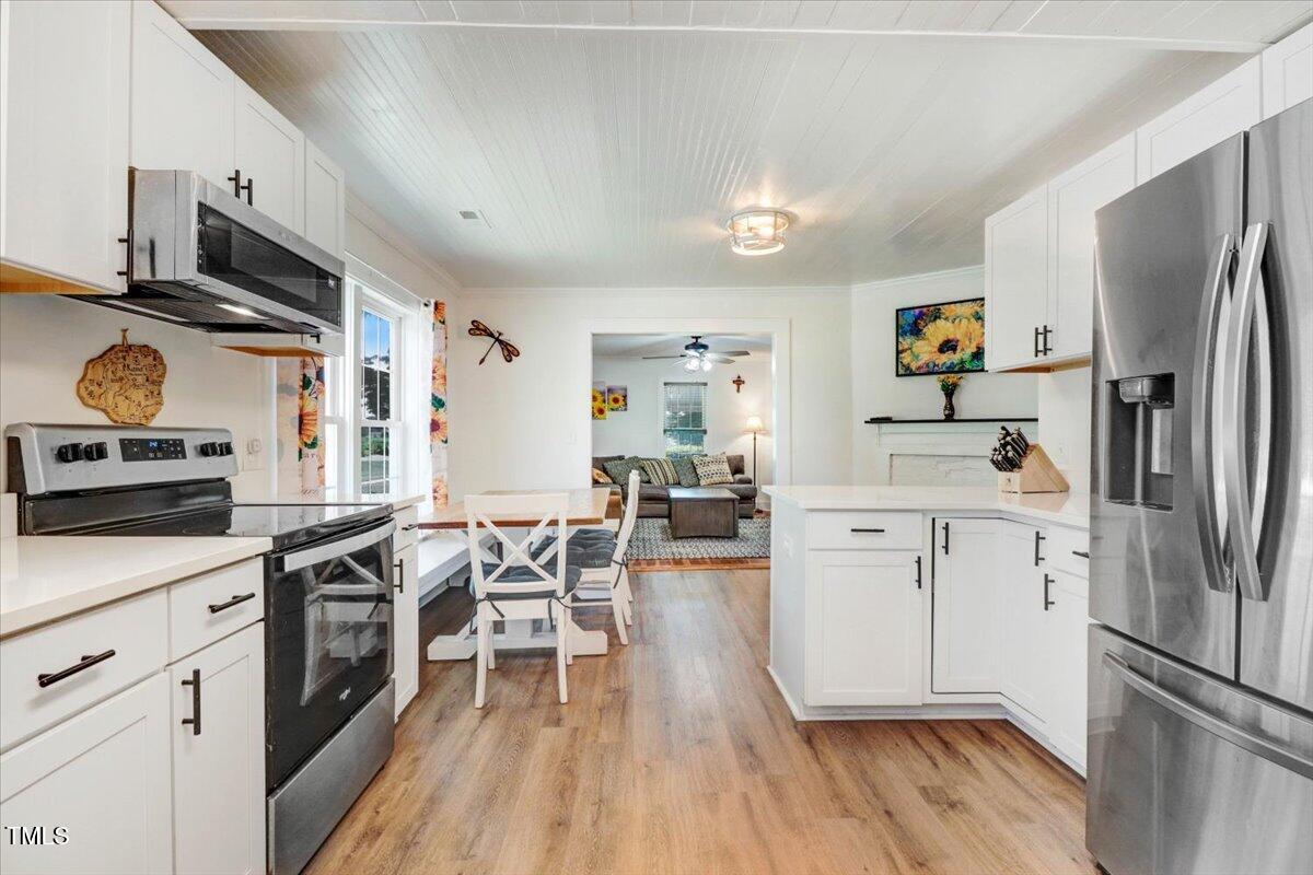 175 Debro Road Kenly, NC 27542 - Photo 13 of 30 a kitchen with white cabinets and stainless steel appliances