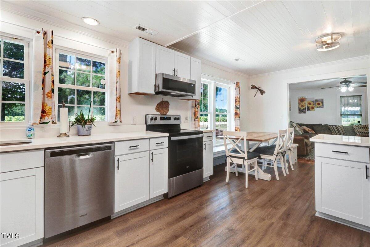 175 Debro Road Kenly, NC 27542 - Photo 14 of 30 a kitchen with a table chairs sink and cabinets