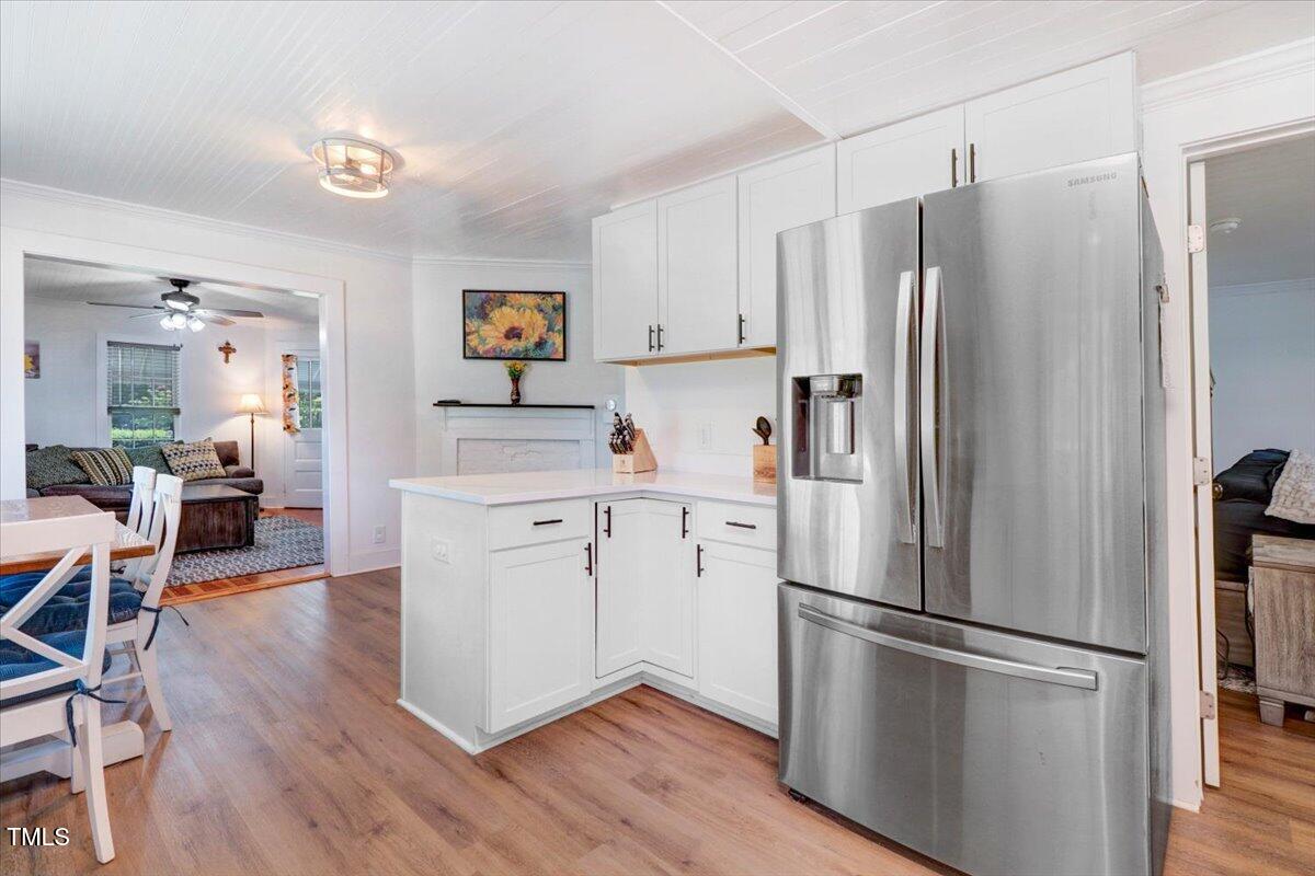 175 Debro Road Kenly, NC 27542 - Photo 15 of 30 a kitchen with stainless steel appliances a refrigerator a sink cabinets and wooden floor