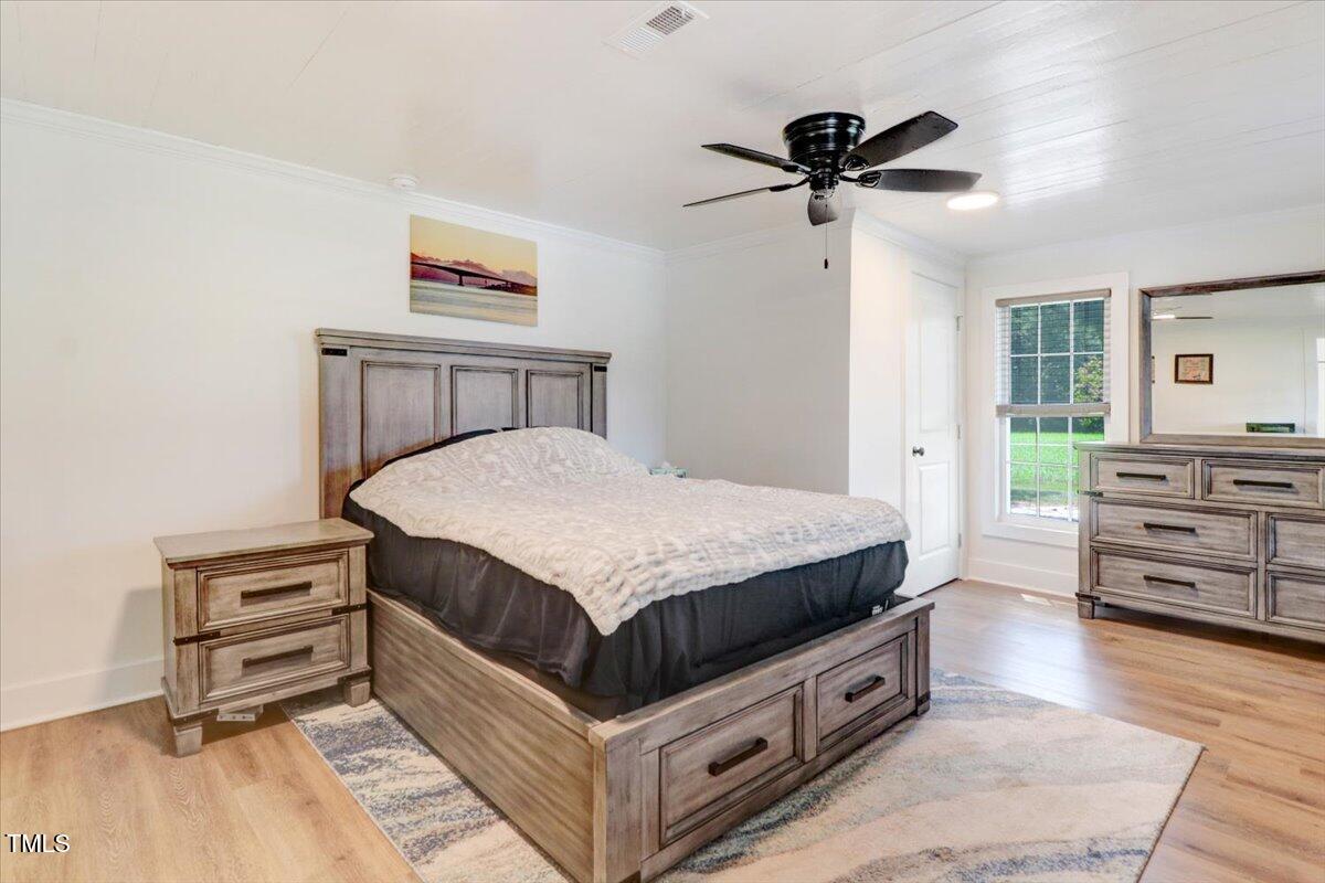 175 Debro Road Kenly, NC 27542 - Photo 16 of 30 a spacious bedroom with a bed and dresser
